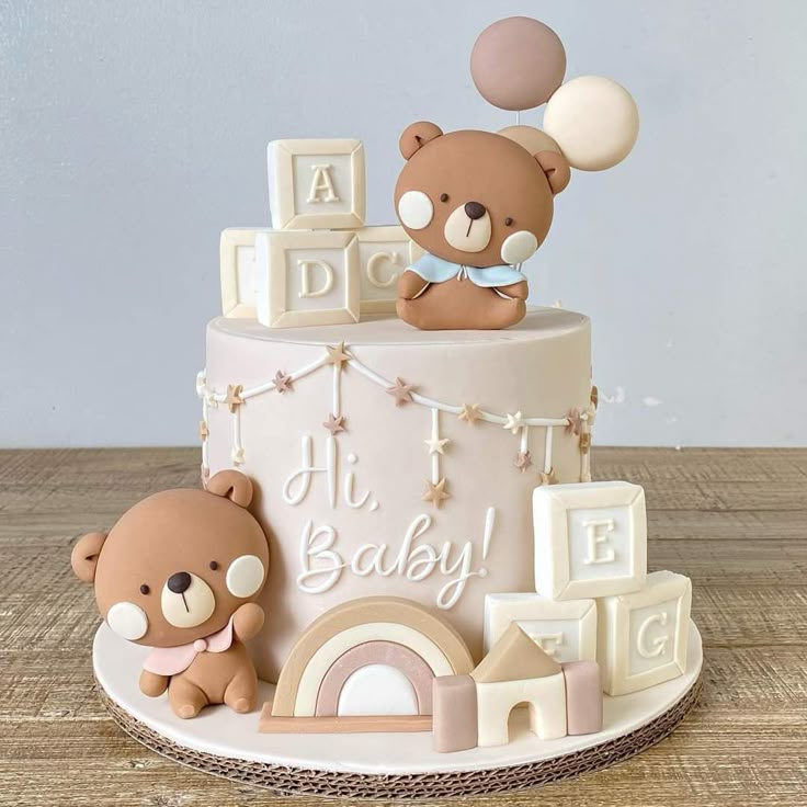 a baby shower cake with teddy bears on top