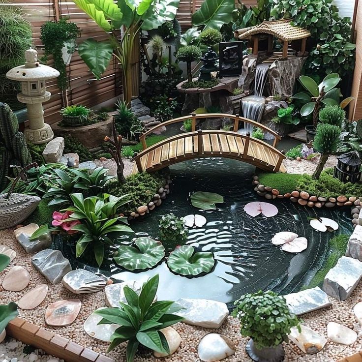 a small pond in the middle of a garden filled with lots of plants and rocks