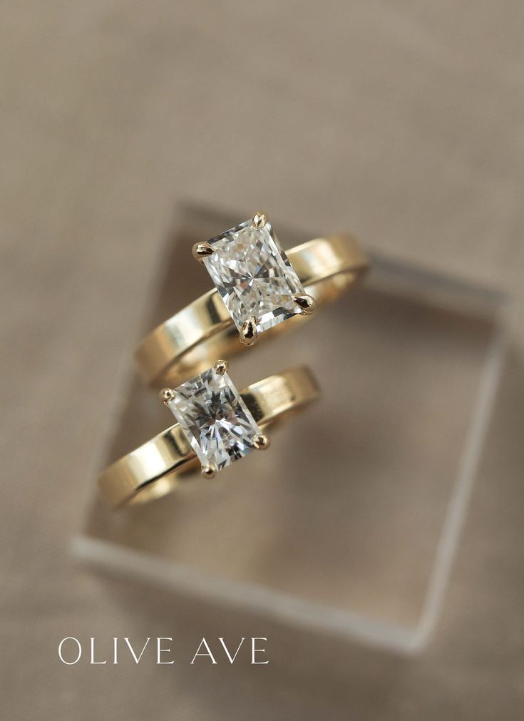 two yellow gold engagement rings with a princess cut diamond