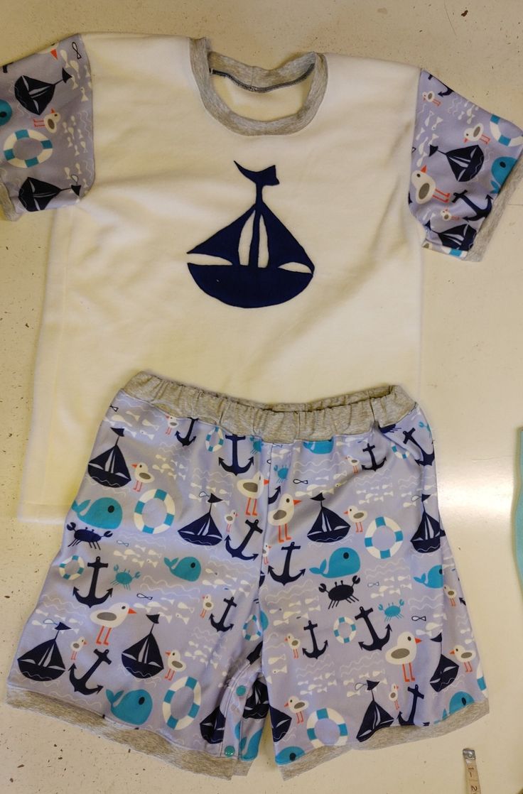 This is a listing for a 2 piece short and T shirt style top made with fleece. The shorts will have snaps in the crotch/inner legs, and be made with the full print. The top will be white fleece with the print for the sleeves, and a picture on the front/center (of the ship, or whale, or whichever of the pictures you'd prefer to match the fabric). Please include the following measurements in inches: chest hips top of thigh (basically all the way around the top of one leg) neck shoulder to crotch sh Diaper Shirt, Shirt Style Tops, Footie Pajama, White Fleece, T Shirt Style, Shorts Set, Shirts & Tops, Short Sets, Short Sleeve Shirt