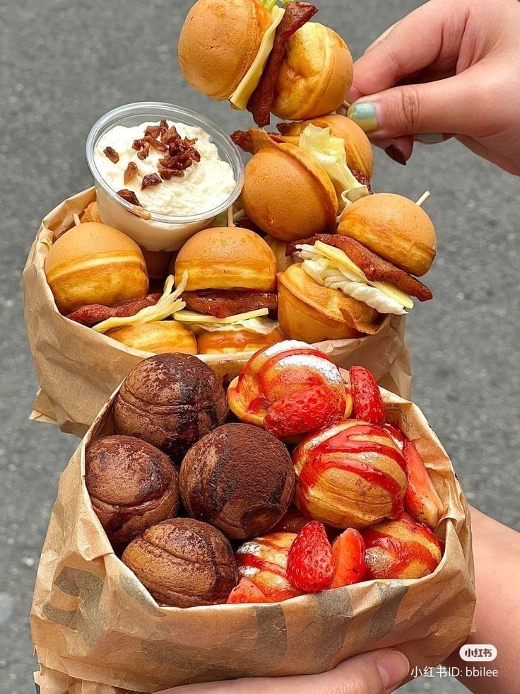 a person is picking up some food from a bag on the street while holding it in their hand