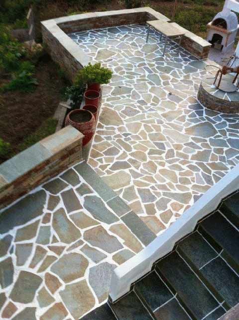 an outdoor pool with steps leading up to it and potted plants on the side