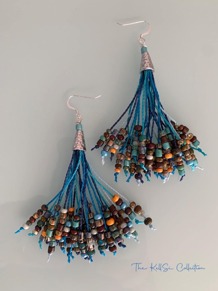 two pairs of beaded earrings with tassels and beads hanging from the ends