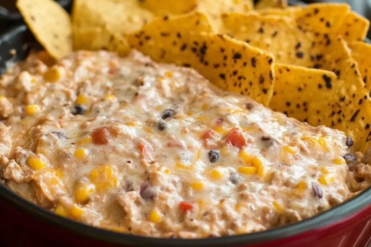 a close up of a bowl of food with tortilla chips