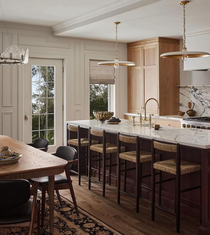 a large kitchen with an island in the middle and lots of counter space on one side