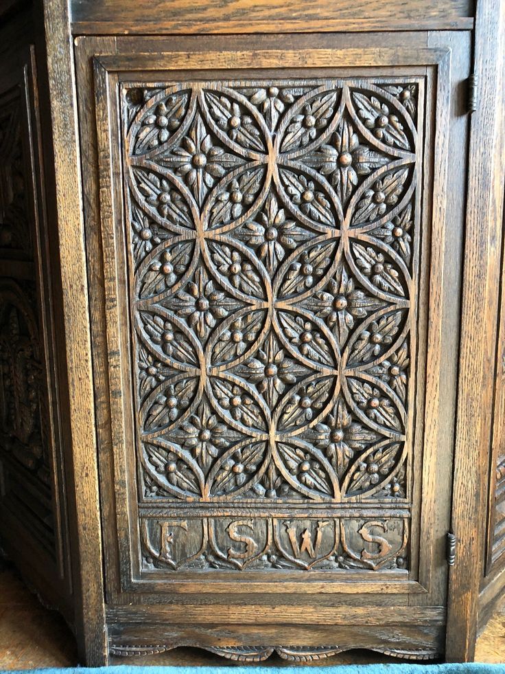 an ornate wooden cabinet with carvings on it