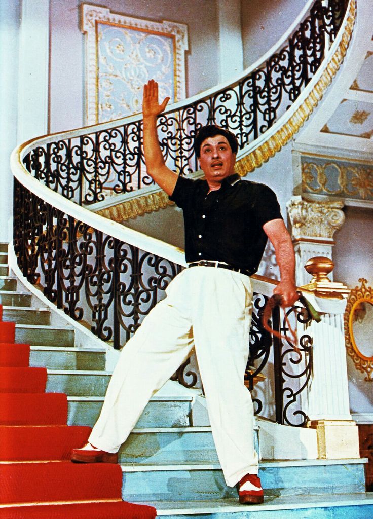 a man is standing on the stairs with his hands in the air