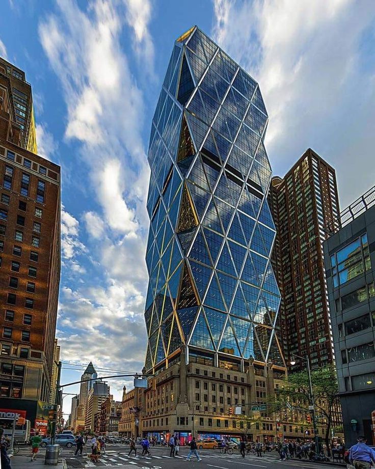 a very tall glass building sitting in the middle of a city