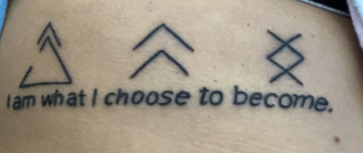 a tattoo saying i am what i choose to become on someone's back leg