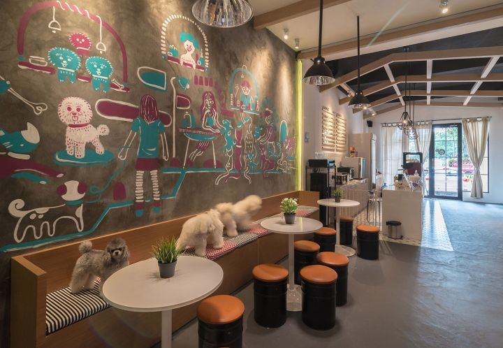 the interior of a restaurant with tables, stools and chalkboard on the wall