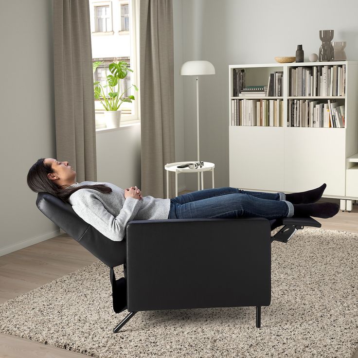 a woman reclining on a chair in a living room