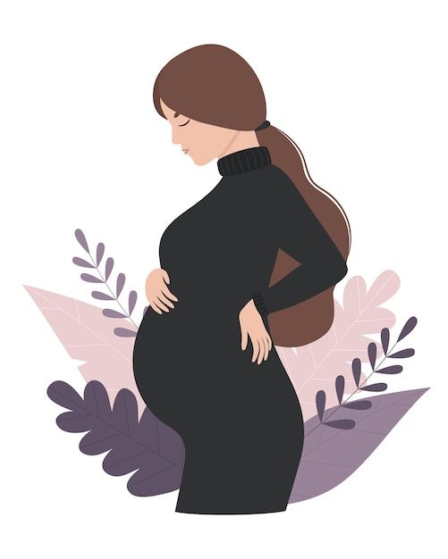 a pregnant woman standing in front of leaves