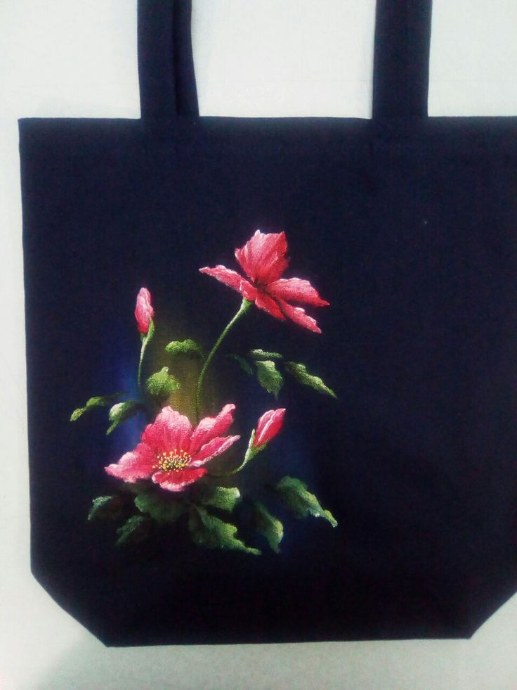 a black bag with pink flowers painted on it