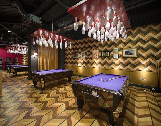 two pool tables with balls hanging from the ceiling