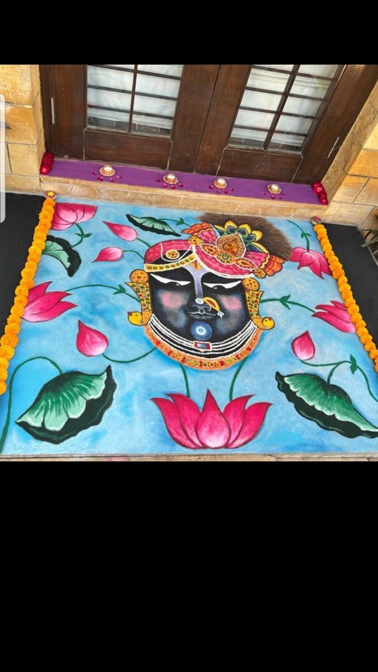 a colorful carpet with flowers on it in front of a door