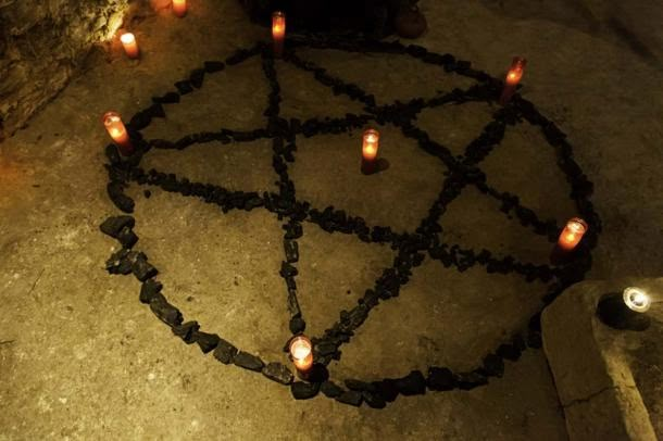 many candles are arranged in the shape of a circle on the floor next to a fire hydrant