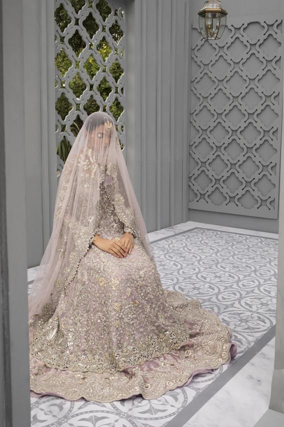 a woman in a wedding dress sitting on the floor with a veil over her head