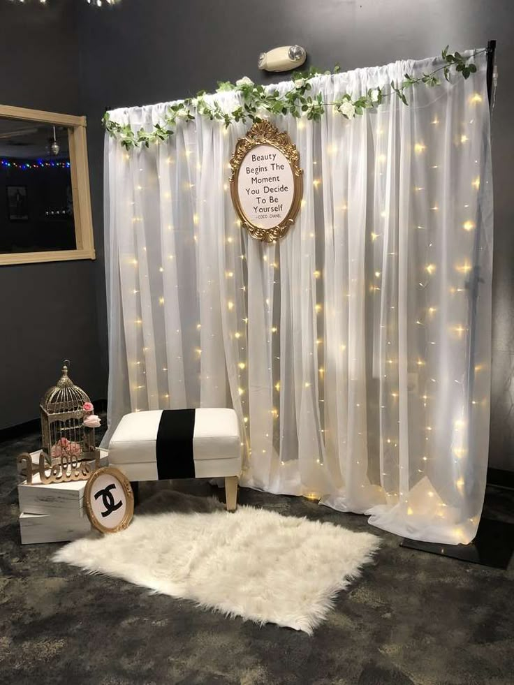 a white bench sitting in front of a curtain