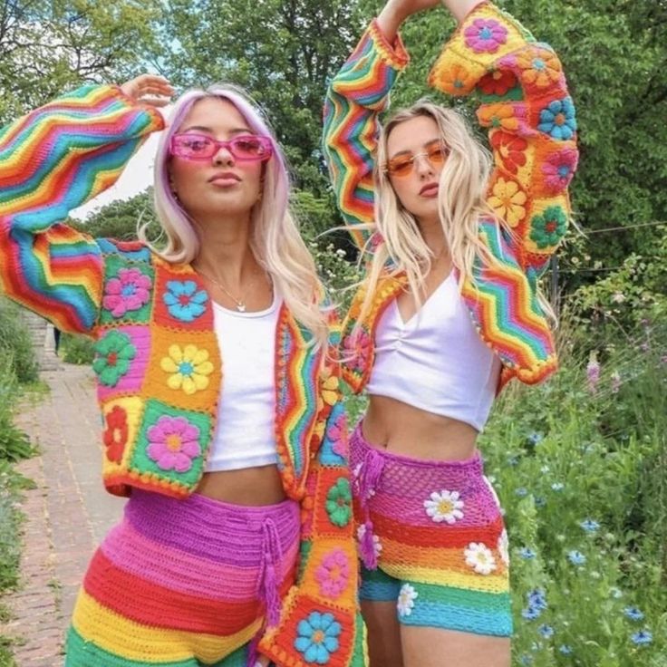 two women in colorful crochet clothing posing for the camera