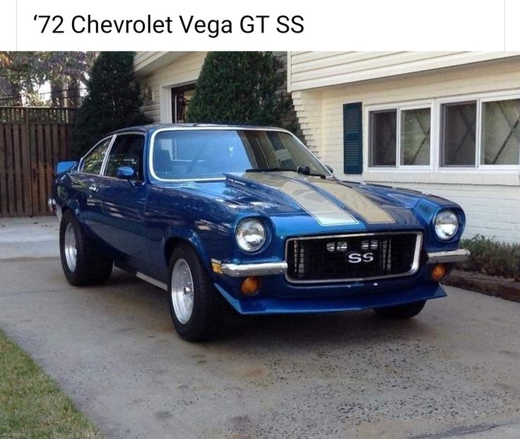 a blue car is parked in front of a house with the words 72 chevrolet vega gts on it