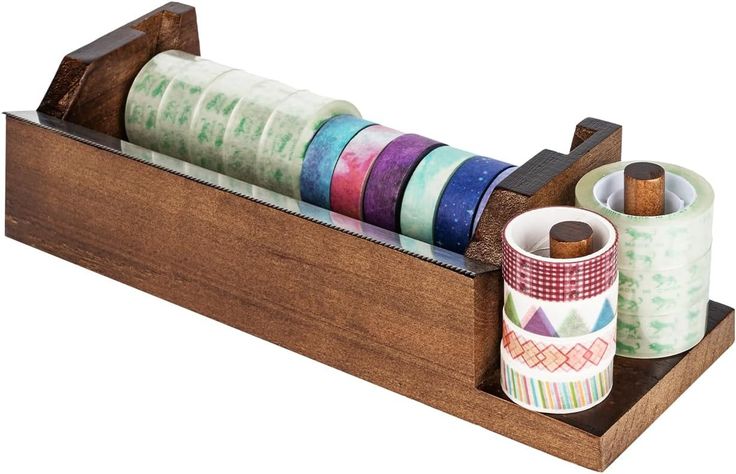 several rolls of washi tape in a wooden holder