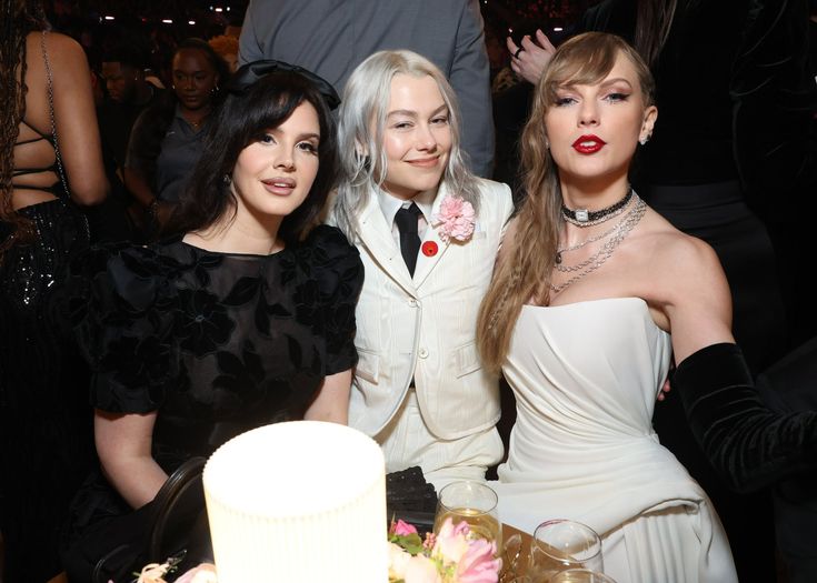 three women sitting next to each other at a party