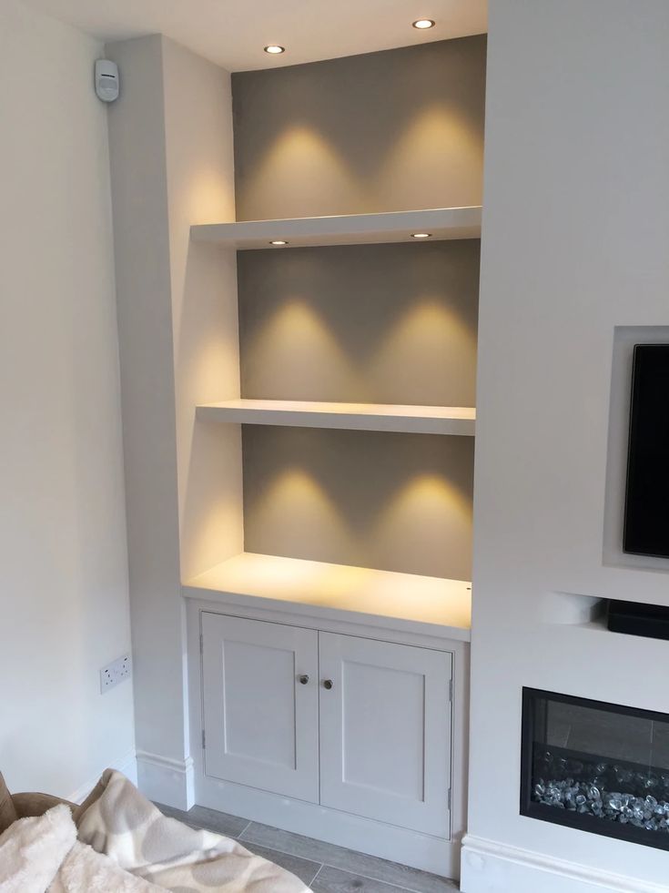 an empty living room with built in bookshelves