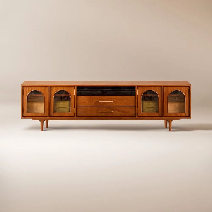 an old fashioned tv stand with glass doors