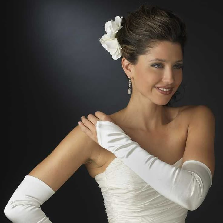 a woman wearing white gloves posing for a photo