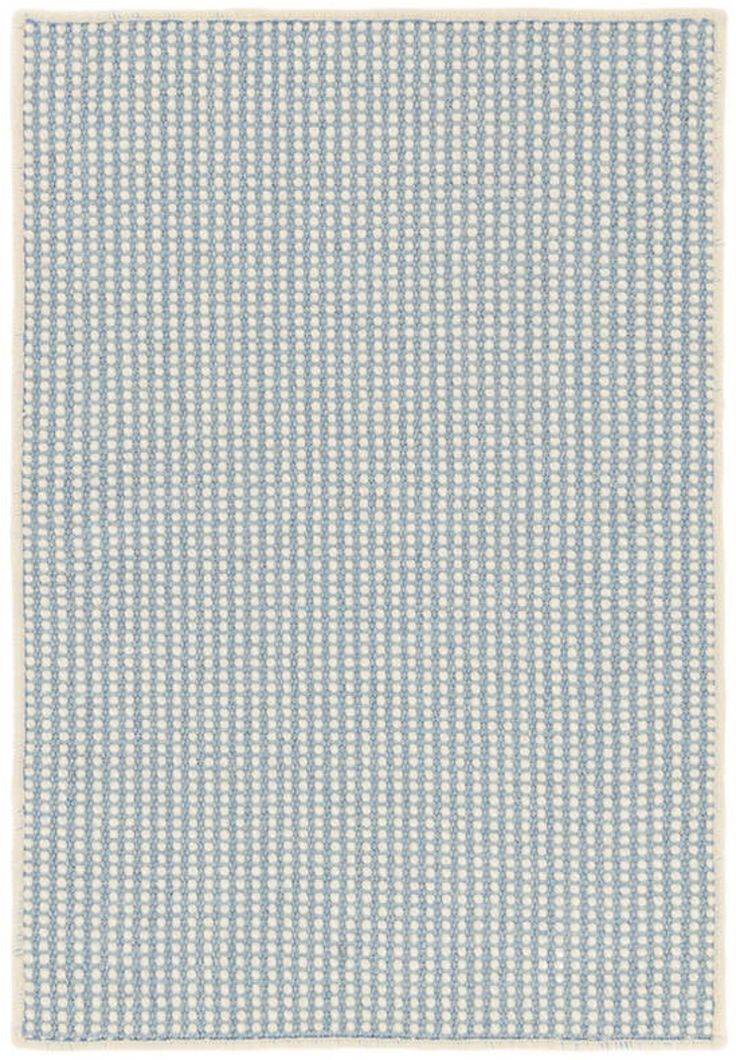 a blue and white rug with small squares on it