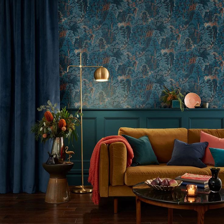 a living room filled with furniture and wallpaper covered in blue floral designs on the walls