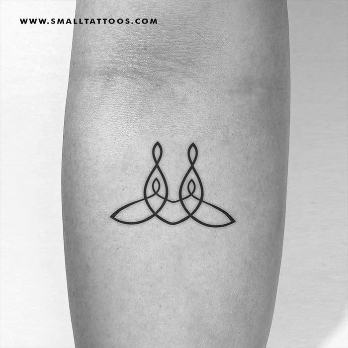 a black and white photo of a tattoo on the leg