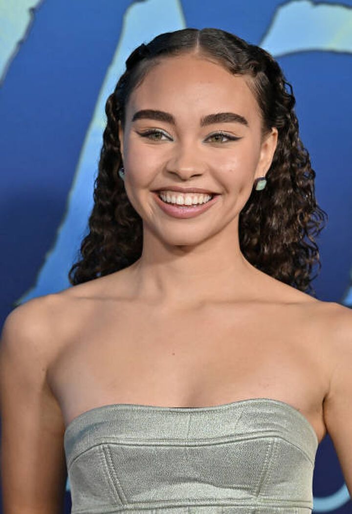 a smiling woman in a strapless dress at the world premiere of aquaworld's avatar