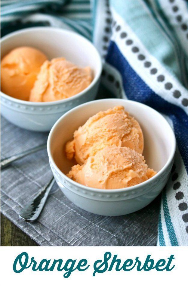 two bowls filled with orange sherbet ice cream on top of a blue and white towel