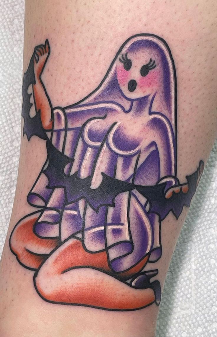 a woman's leg with a tattoo on it that has an image of a ghost