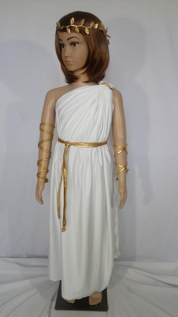 a mannequin wearing a white dress with gold trims on it's head