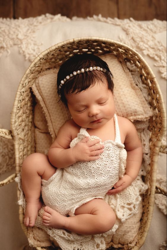 a newborn baby is sleeping in a basket