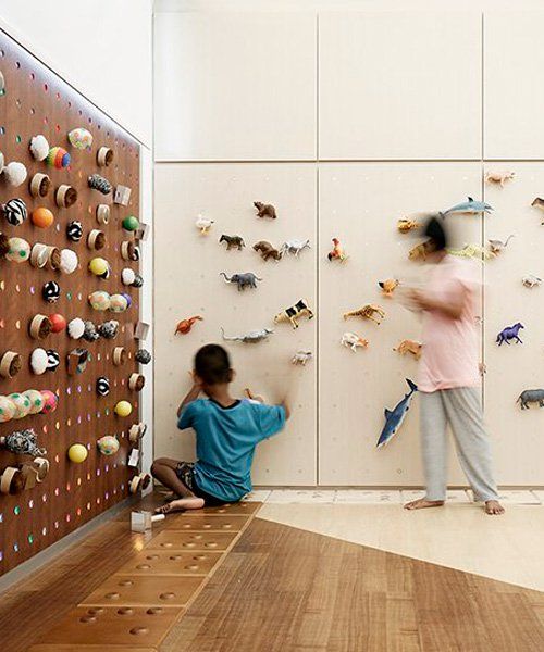 two people standing in front of a wall with magnets on it