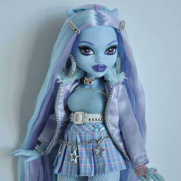 a doll with blue hair wearing a dress and silver accessories on it's head