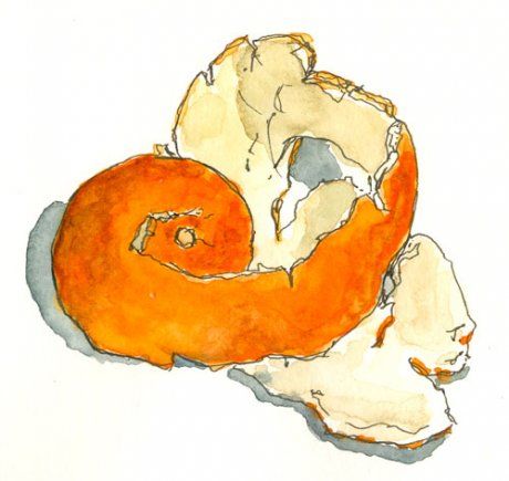 an orange and white donut sitting on top of a piece of torn up paper