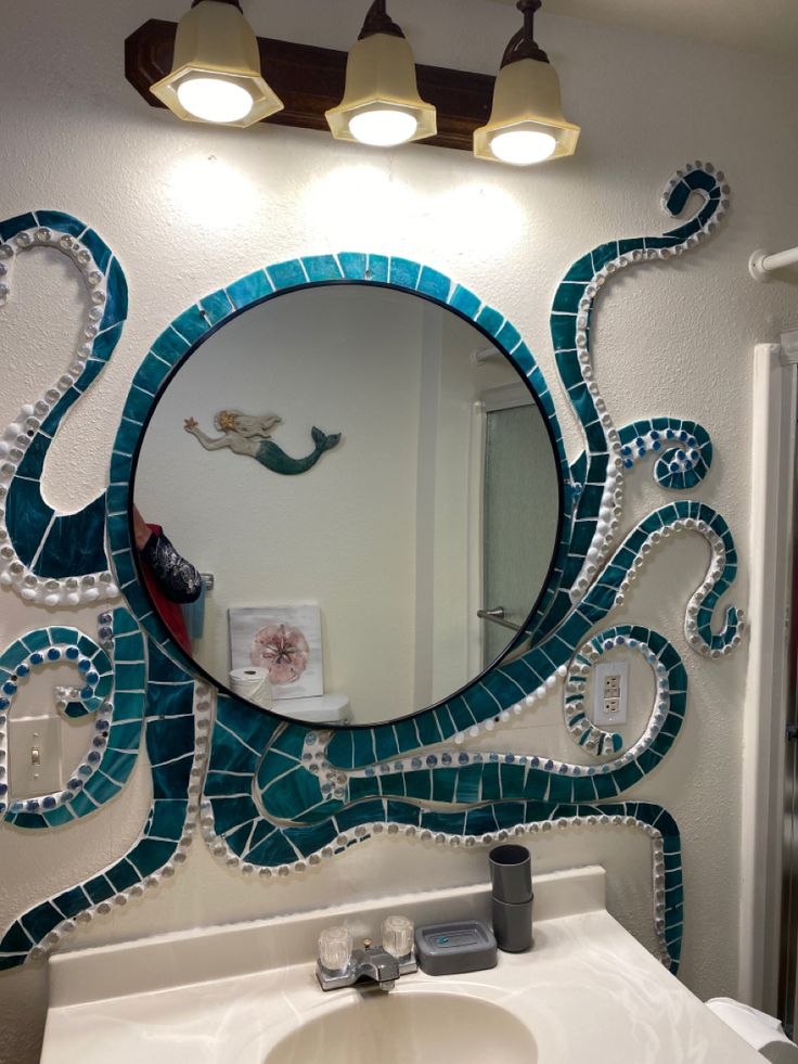 a bathroom mirror with an octopus design on it