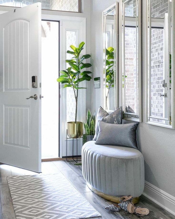 a living room filled with furniture and mirrors