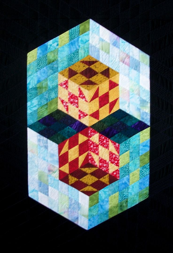 a quilted block with two cubes in it's center and one on the other