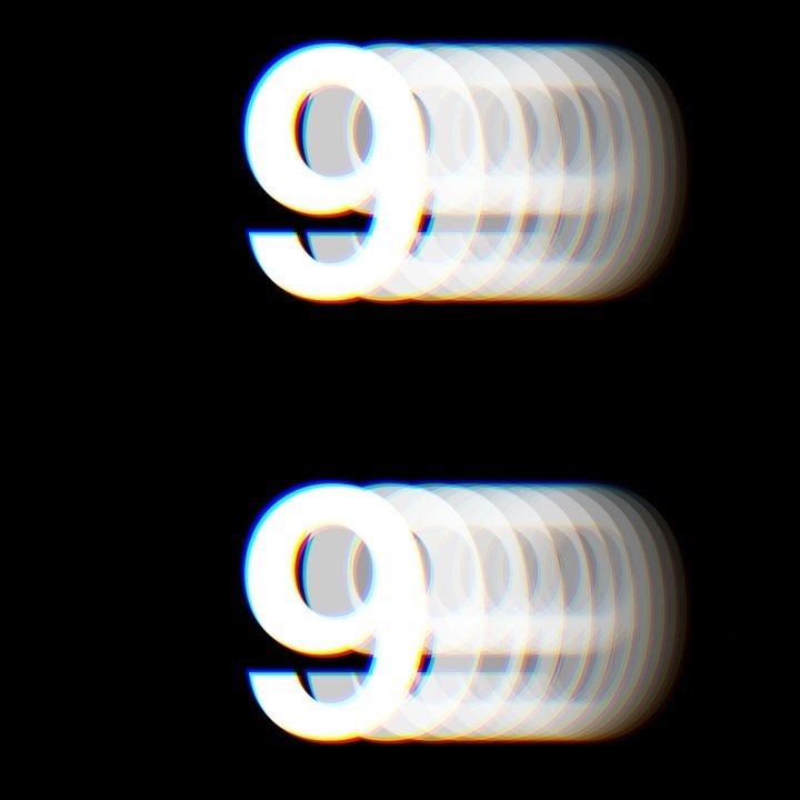 two white letters that are on top of each other in the dark, with light coming from them