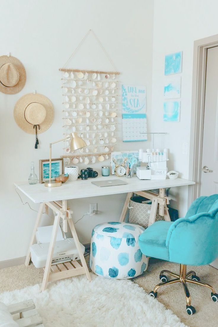 a room with a desk, chair and pictures on the wall above it is also a white rug