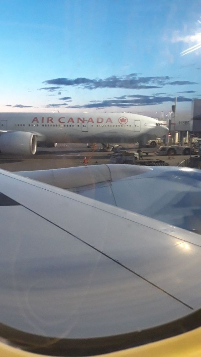 an air canada jetliner sitting on top of an airport tarmac