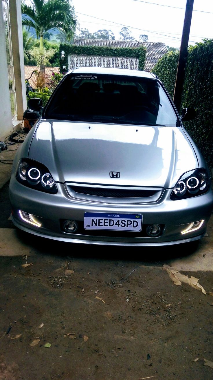 a silver car parked in front of a house