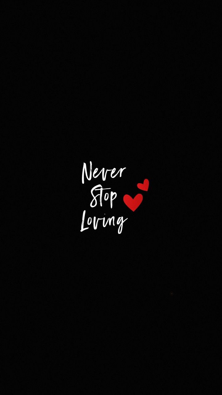 the words never stop loving are written in white ink on a black background with a red heart