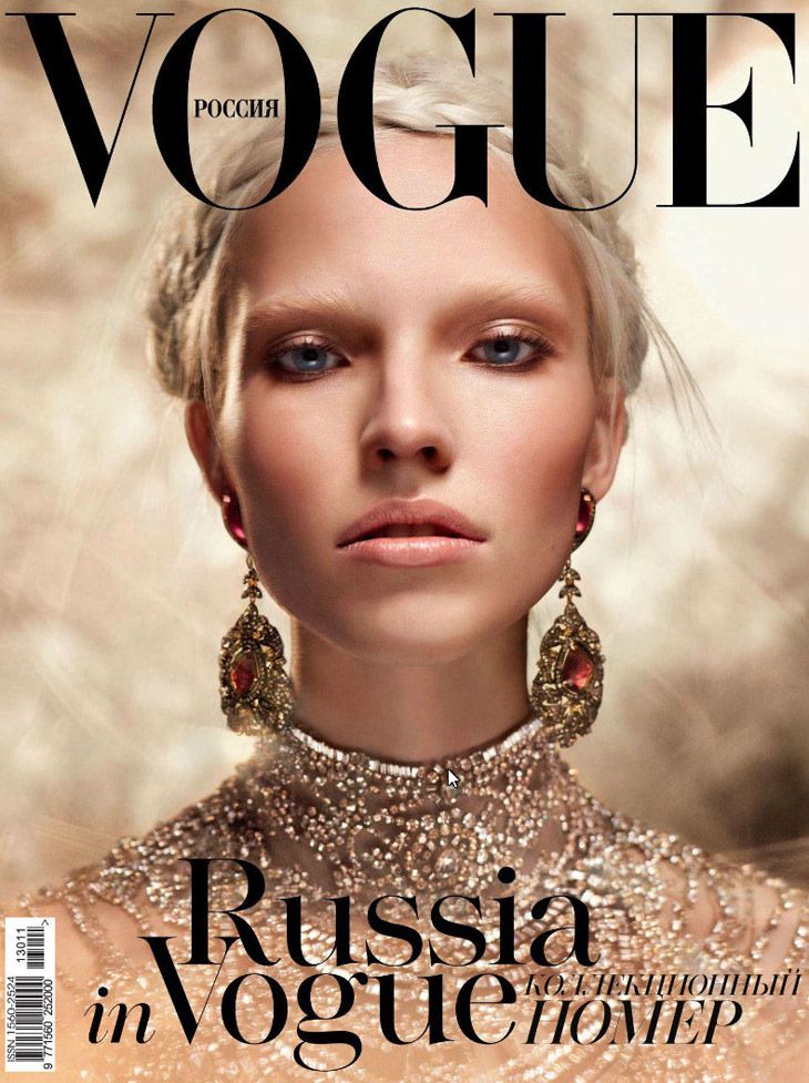 a woman with blonde hair and earrings on the cover of a magazine