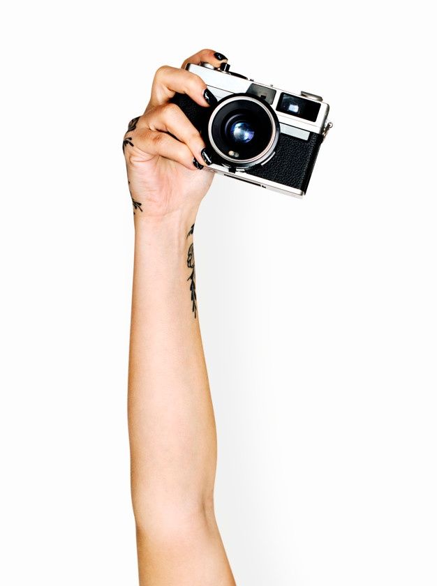 a person holding up a camera in the air